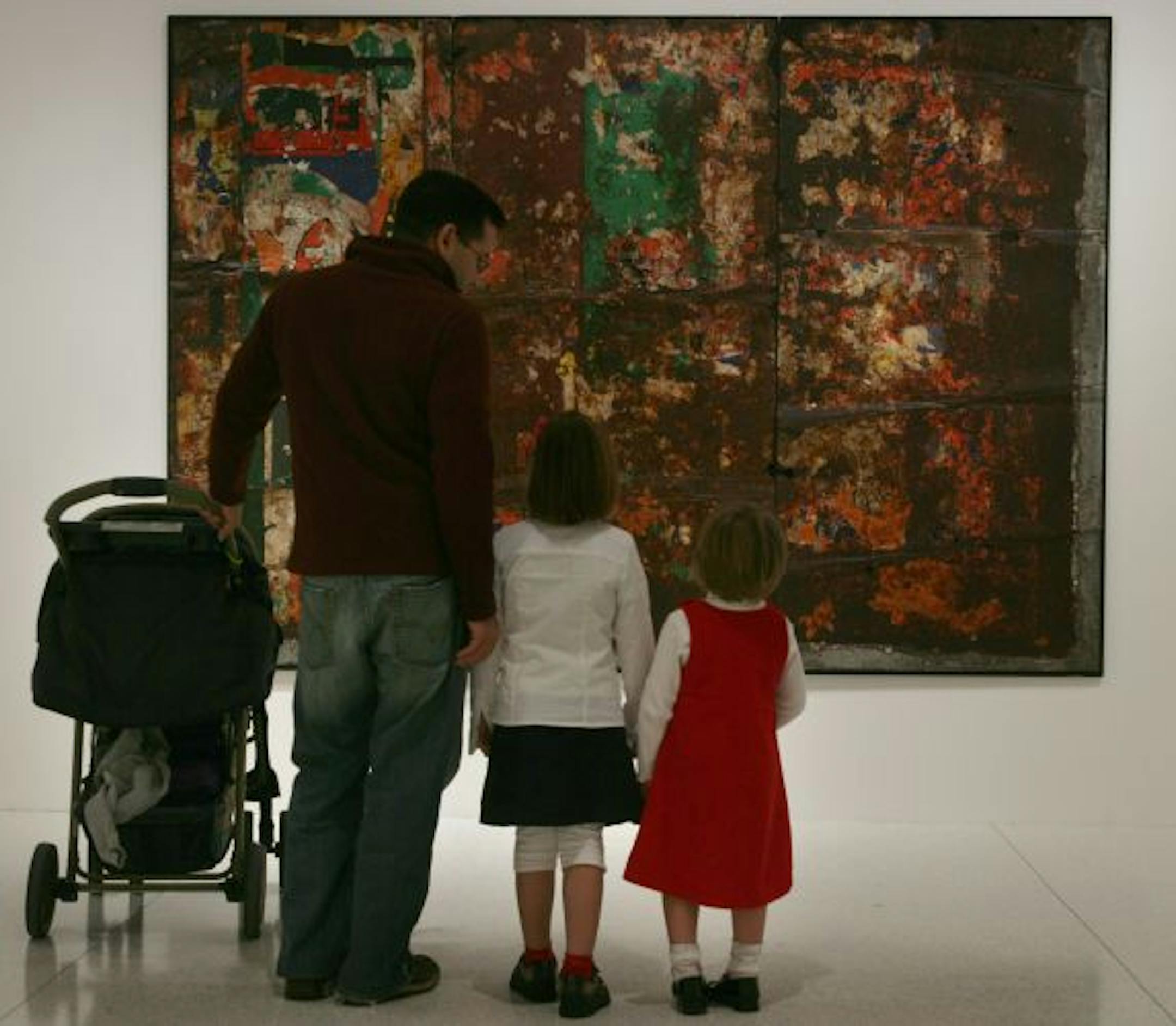 Rick Cases of Edina, brought his children Rose, Iris and Dahlia (in stroller) to tour thru the "Event Horizon" exhibit. They are looking at Raymond Hains' Untitled, 1959-1960.