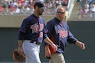 Twins pitcher Nick Blackburn left the field with trainer Dave Pruemer after being injured in the 6th inning of a game in 2012.