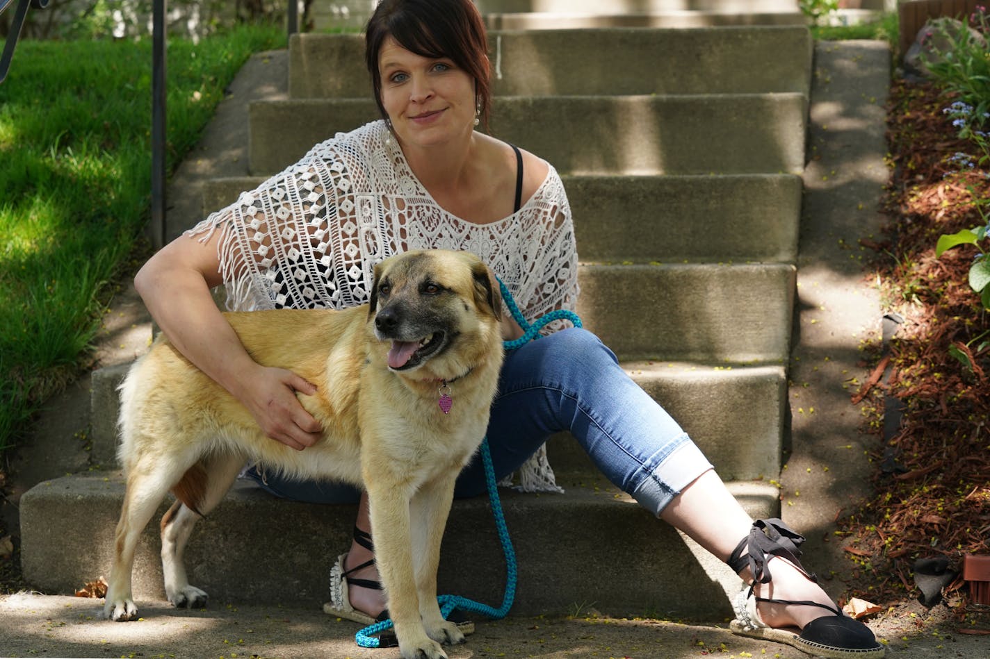 Seneca Krueger sat for a portrait with her dog Zelda Friday, May 15, 2020 outside her home in St. Paul.