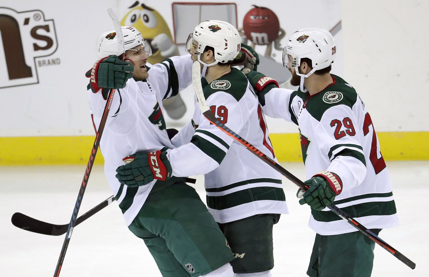 Minnesota Wild players, from left, Marcus Foligno, Luke Kunin and Greg Pateryn celebrate Kunin's goal against the New Jersey Devils during the third period of an NHL hockey game, Saturday, Feb. 9, 2019, in Newark, N.J. The Wild won 4-2. (AP Photo/Julio Cortez)