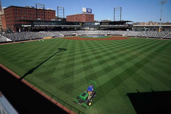 A member of the grounds crew striped the outfield ahead of a St. Paul Saints workout last May at CHS Field.