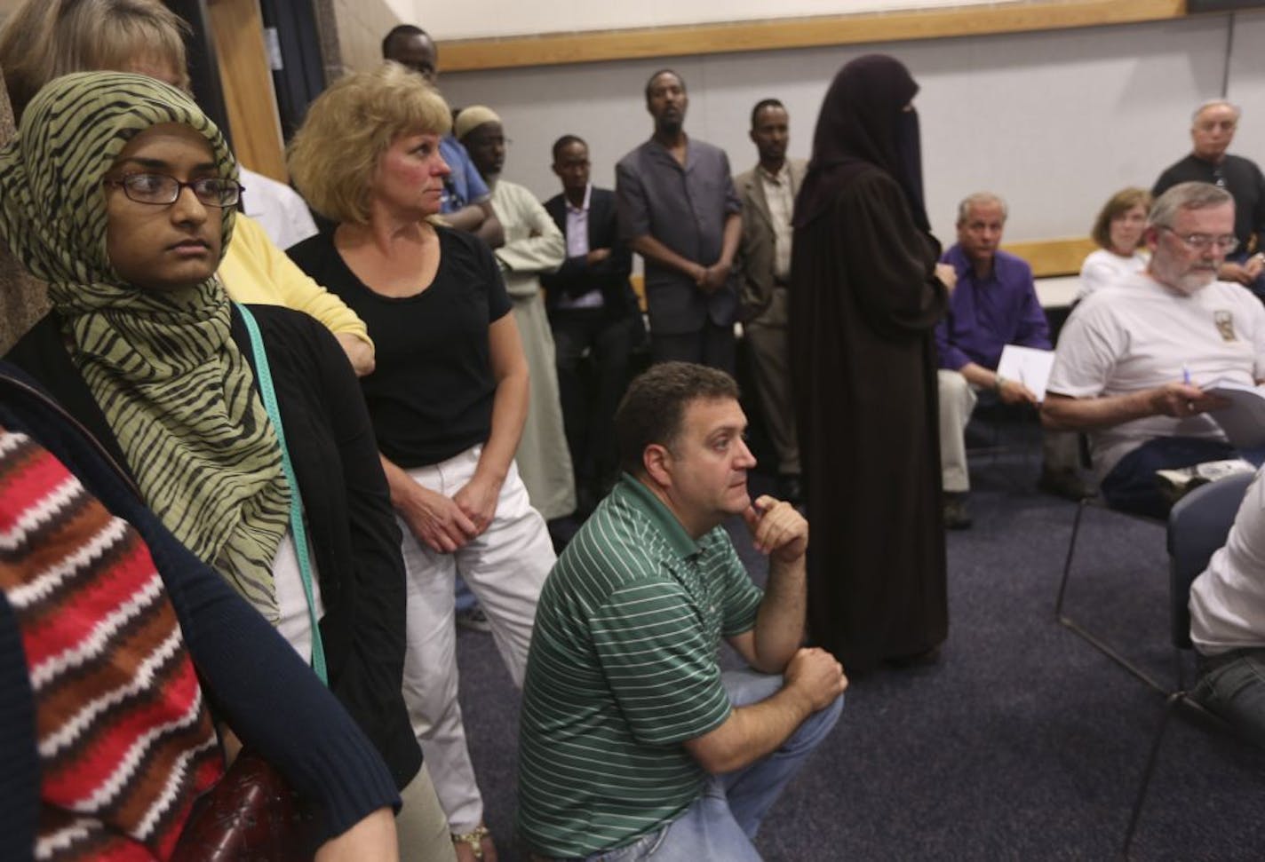 People stood along the wall as the room filled up during a city council meeting as they decided on a proposed Islamic center in St Anthony Village on June 12, 2012.