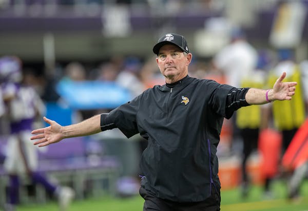 Mike Zimmer cheered with the crowd as he made his way off the field after a game vs. Oakland.