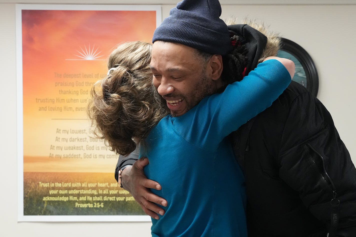 Registered nurse Chris Niederer with SoleCare for Souls gives a hug to Brian Campbell after working on his feet Wednesday, March 1, 2023 at the Catholic Charities Opportunity Center in Minneapolis. ] ANTHONY SOUFFLE • anthony.souffle@startribune.com