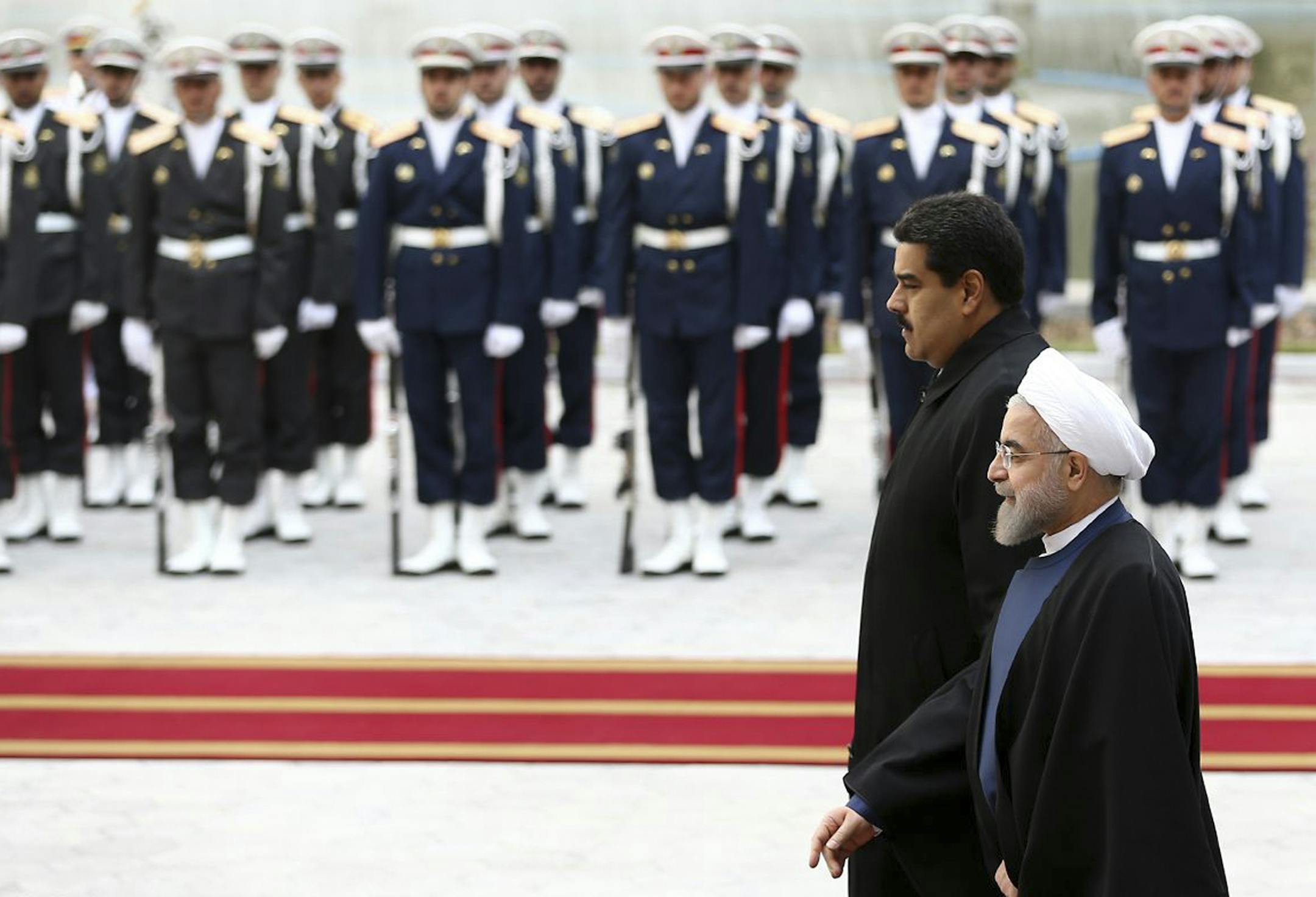 In this photo released by the official website of the office of the Iranian Presidency, Venezuelan President Nicolas Maduro, left, is welcomed by his Iranian counterpart Hassan Rouhani during his official arrival ceremony at the Saadabad Palace in Tehran, Iran, Saturday, Jan. 10, 2015. (AP Photo/Iranian Presidency Office, Mohammad Berno)