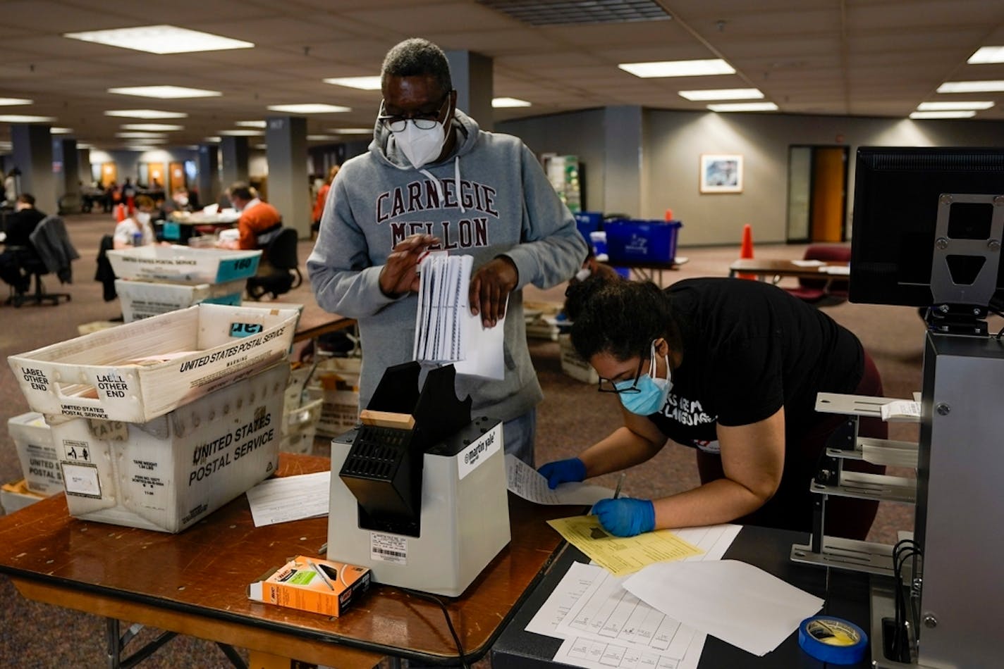 Workers count Milwaukee County ballots on Election Day at Central Count on Tuesday, Nov. 3, 2020, in Milwaukee. (AP Photo/Morry Gash)