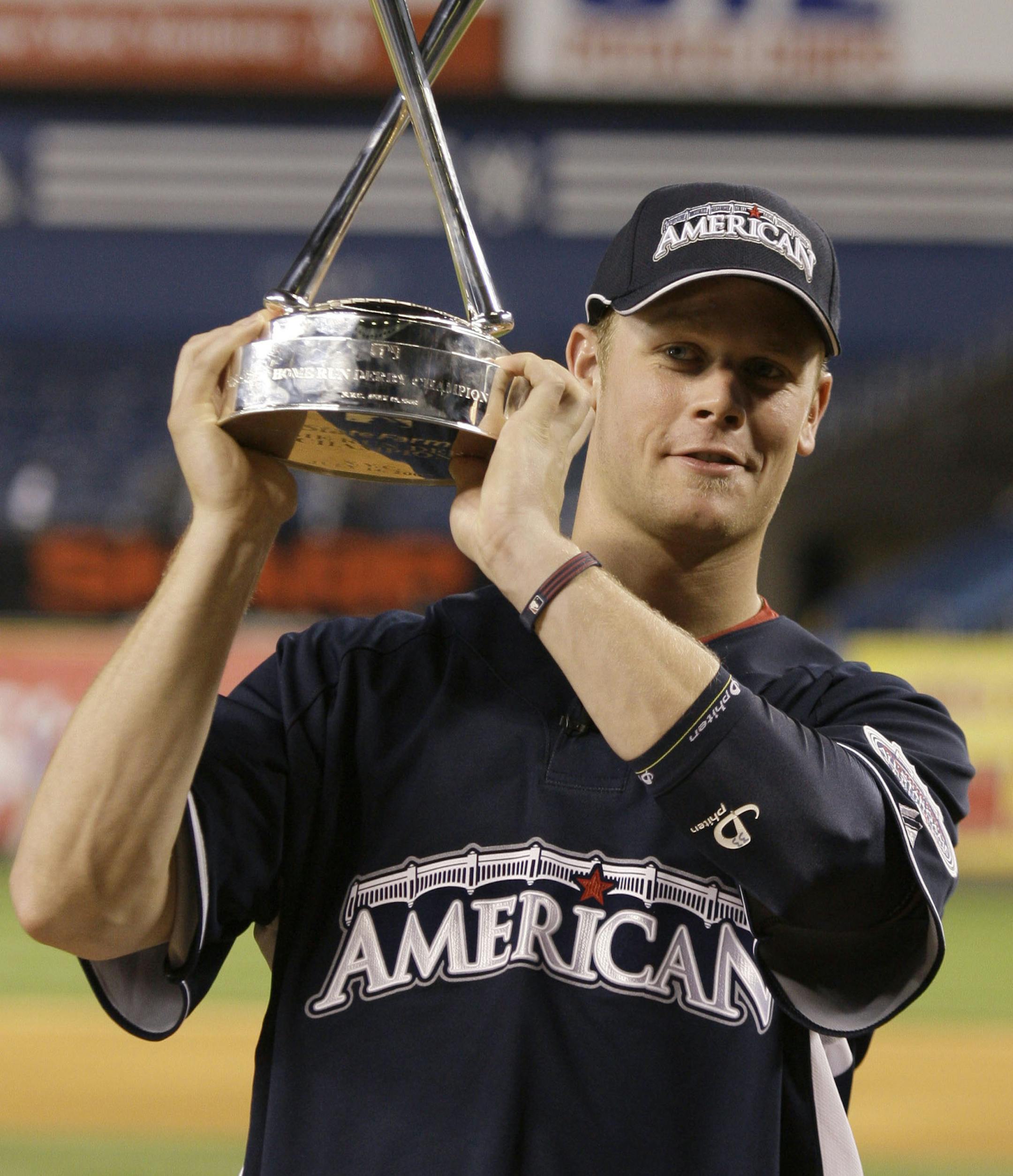 Minnesota Twins' Justin Morneau poses with the trophy after winning baseball's All-Star Home Run Derby at Yankee Stadium in New York on Monday, July 14, 2008. (AP Photo\Kathy Willens) ORG XMIT: NYY140
