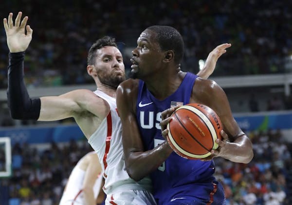 United States� Kevin Durant, right, drives to the basket against Spain�s Ricky Rubio, left, during a men's semifinal round basketball game at the 