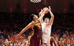 Gophers junior Dawson Garcia (3) blocked a shot from Illinois' Coleman Hawkins on Wednesday in Champaign, Ill.