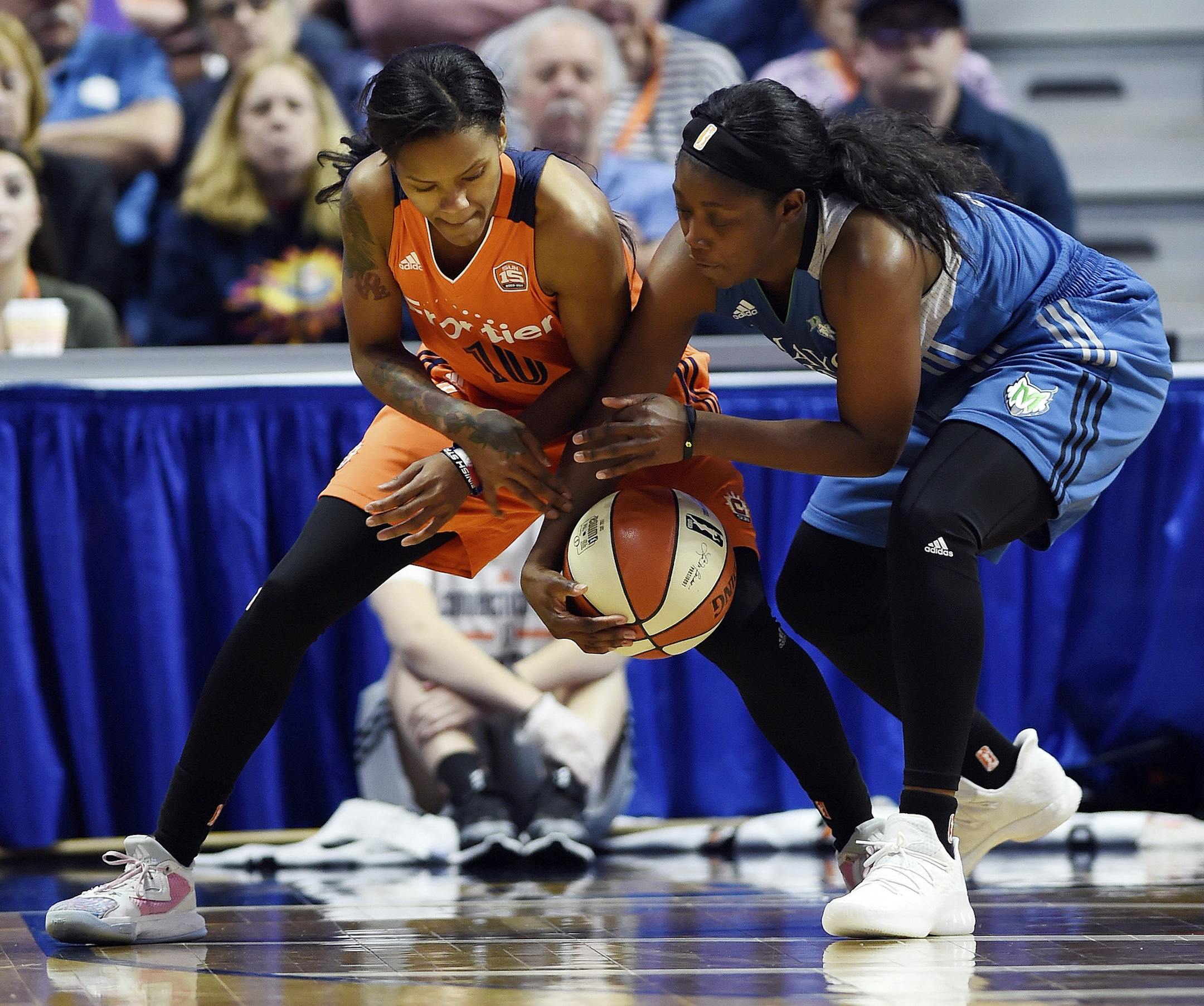Minnesota Lynx's Alexis Jones, right, takes the ball away from Connecticut Sun's Courtney Williams in the second half of a WNBA basketball game Friday, May 26, 2017, in Uncasville, Conn.. (Sean D. Elliot/The Day via AP)