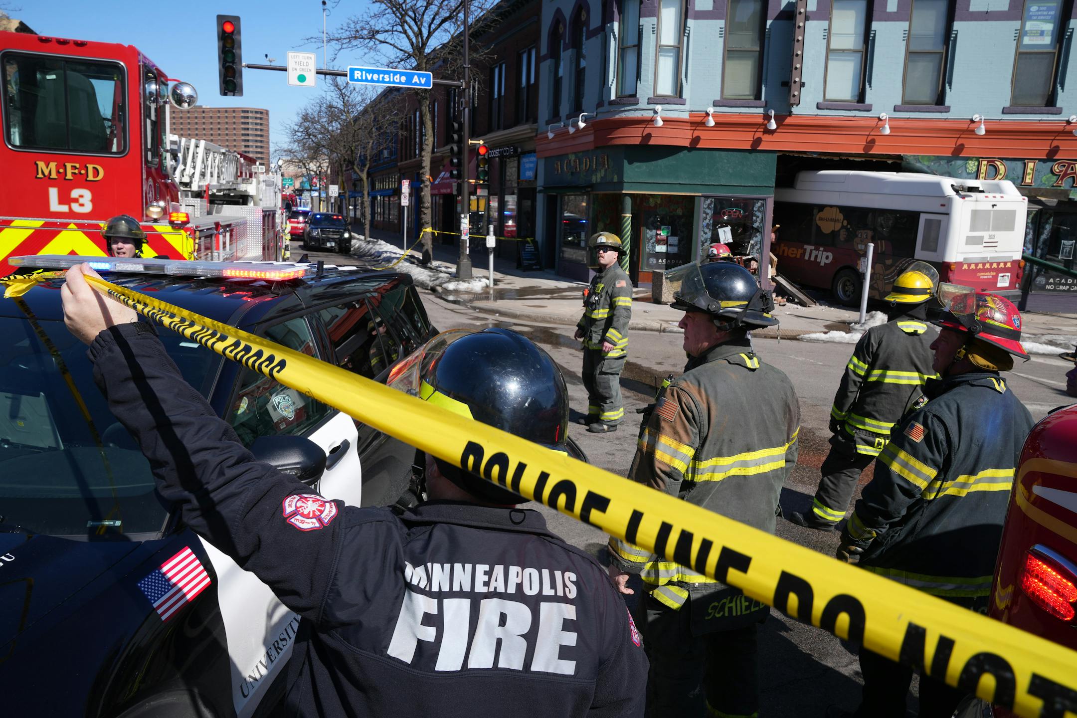 University of Minnesota police and city firefighters survey the scene after a University bus crashed into the Acadia restaurant Tuesday, March 15, 2022 near the intersection of the intersection of Cedar and Riverside Avenues in Minneapolis. ] ANTHONY SOUFFLE • anthony.souffle@startribune.com