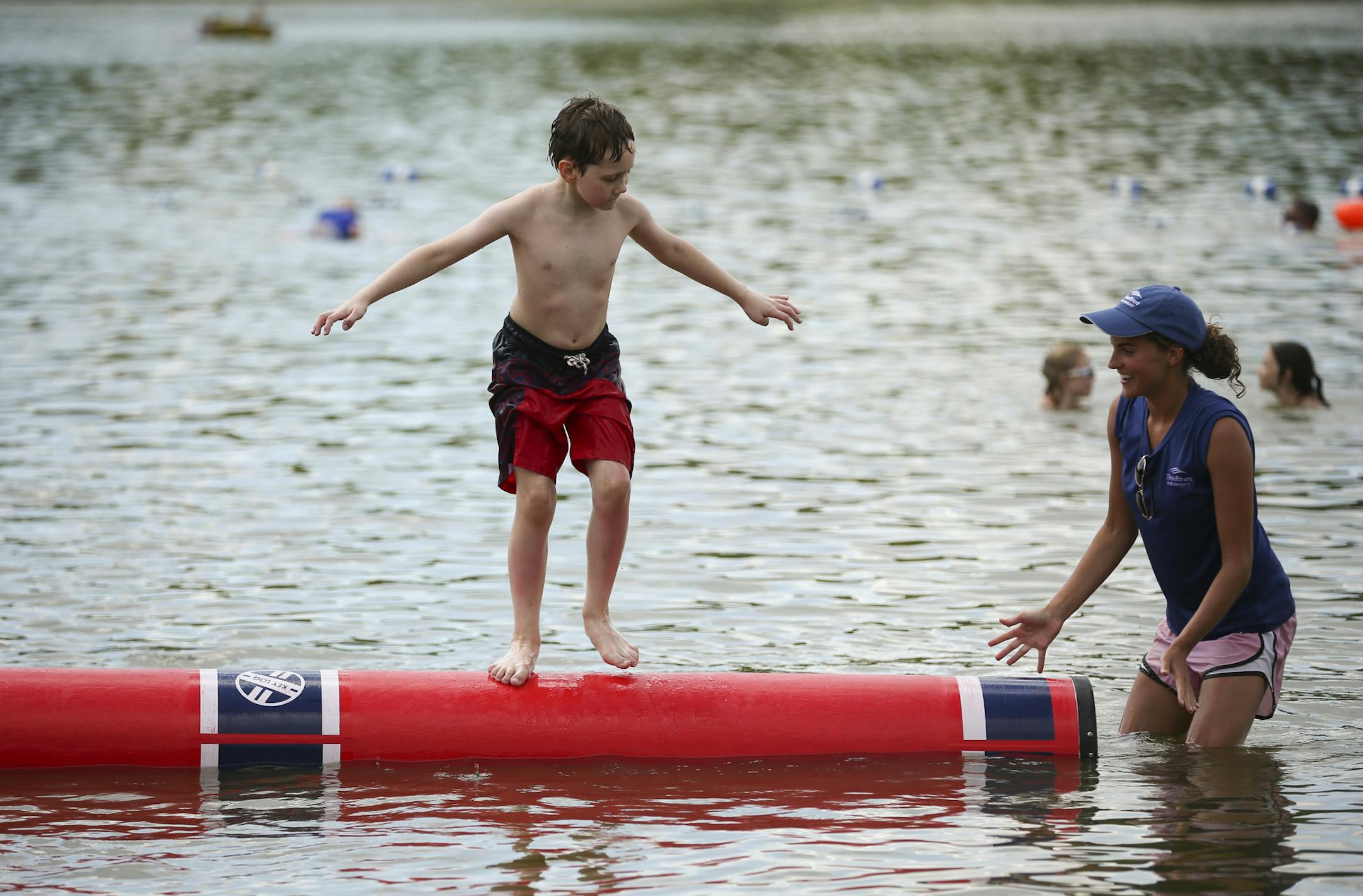 Class participant Benjamin Perrault, 9, worked with outdoor educator Laura Wooley during the workshop Sunday afternoon at Fish Lake Regional Park. ] JEFF WHEELER &#xef; jeff.wheeler@startribune.com The Three Rivers Park District presented a Family Log Rolling workshop at Fish Lake Regional Park in Maple Grove Sunday afternoon, July 26, 2015. On what proved to be a perfect day for it, participants learned techniques for log rolling from outdoor educators and then got to practice. The next class f