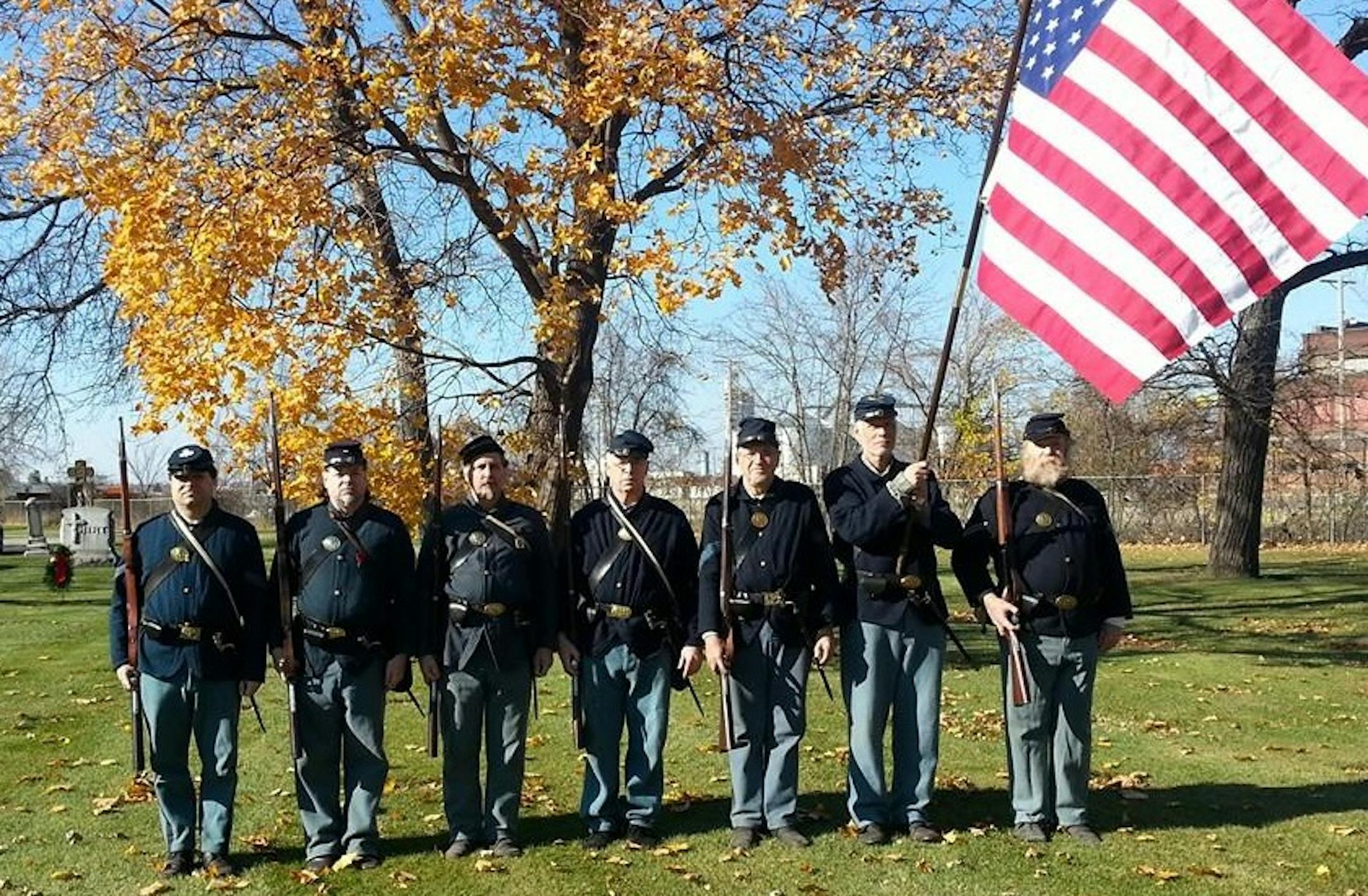 Reenactment soldiers attended the dedication ceremony Saturday for Cpl. Daniel Bracken's new headstone at St. Anthony Cemetery in northeast Minneapolis.