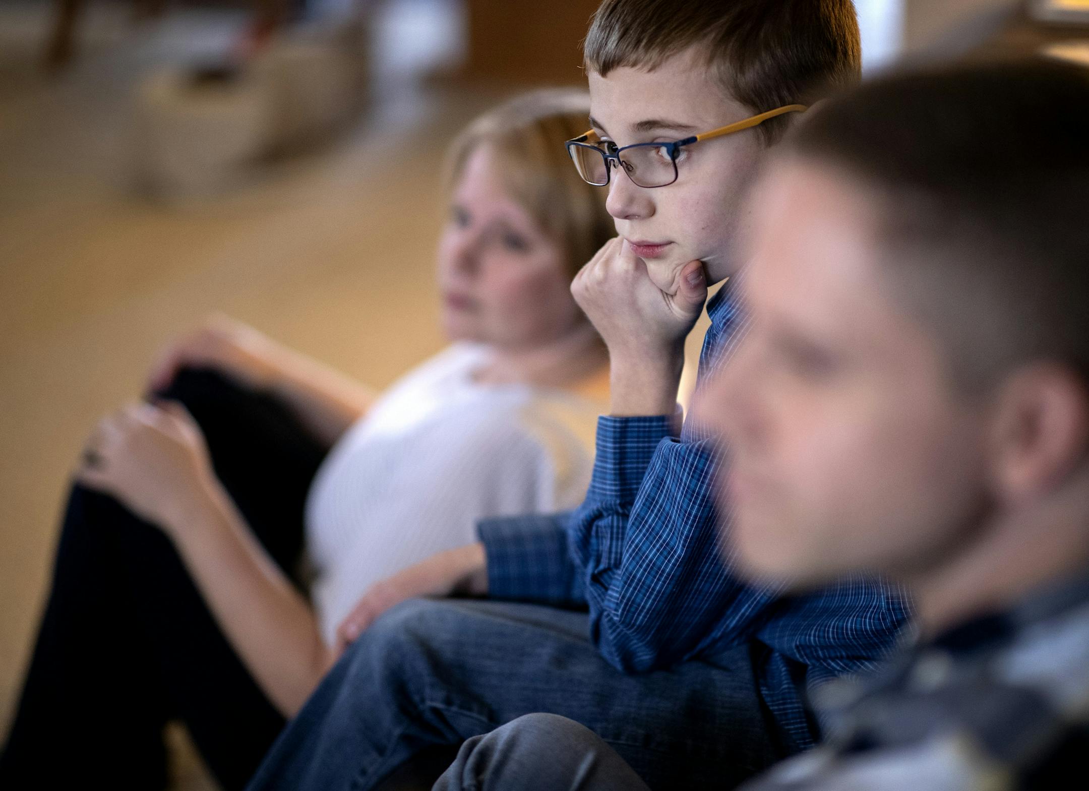 Kari, CJ, 12, and Patrick Cummings on their couch at their home in Crystal. ] CARLOS GONZALEZ &#x2022; cgonzalez@startribune.com &#x2013; Crystal, MN &#x2013; November 6, 2019, Kari Ann and Patrick Cummings of Crystal have two adopted sons both named Caleb. They share their adoption story in light of National Adoption Month