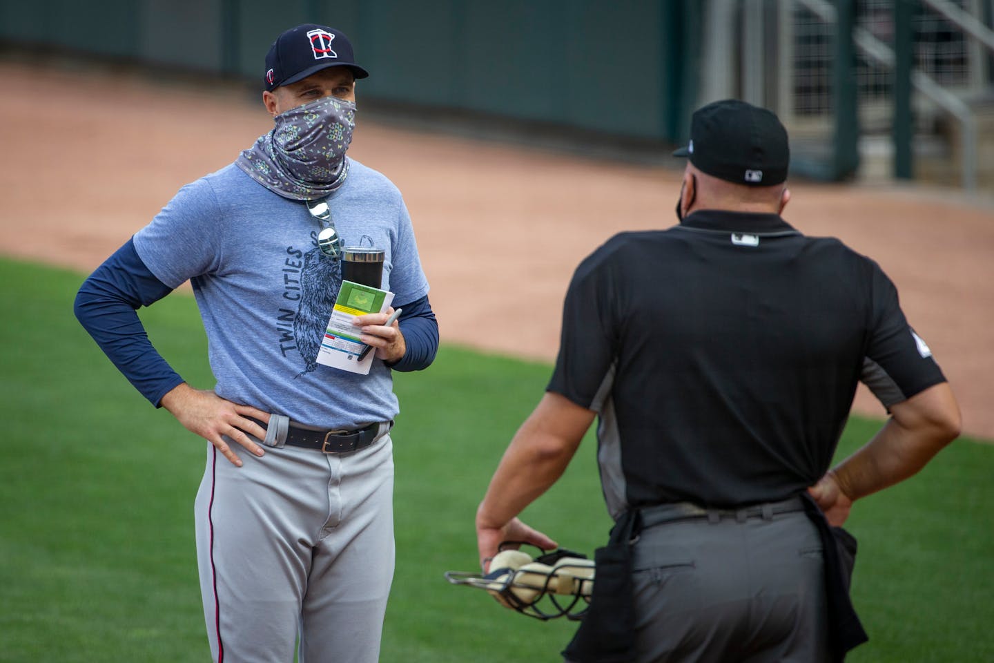 Twins manager Rocco Baldelli speaks with umpire Jeff Nelson prior to an intrasquad game in July