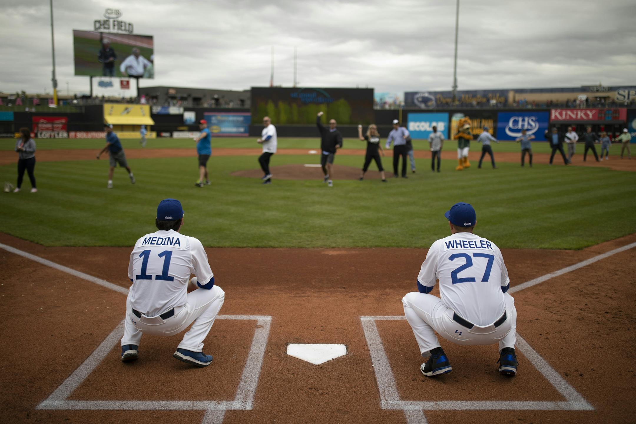 Pitchers Eddie Medina and Beck Wheeler were among the Saints player catching a mass ceremonial first pitch made up of St. Paul Chamber of Commerce members before Monday's home opener. ] JEFF WHEELER ï jeff.wheeler@startribune.com The St. Paul Saints faced the Chicago Dogs in their home opener Monday afternoon at CHS Field in St. Paul.