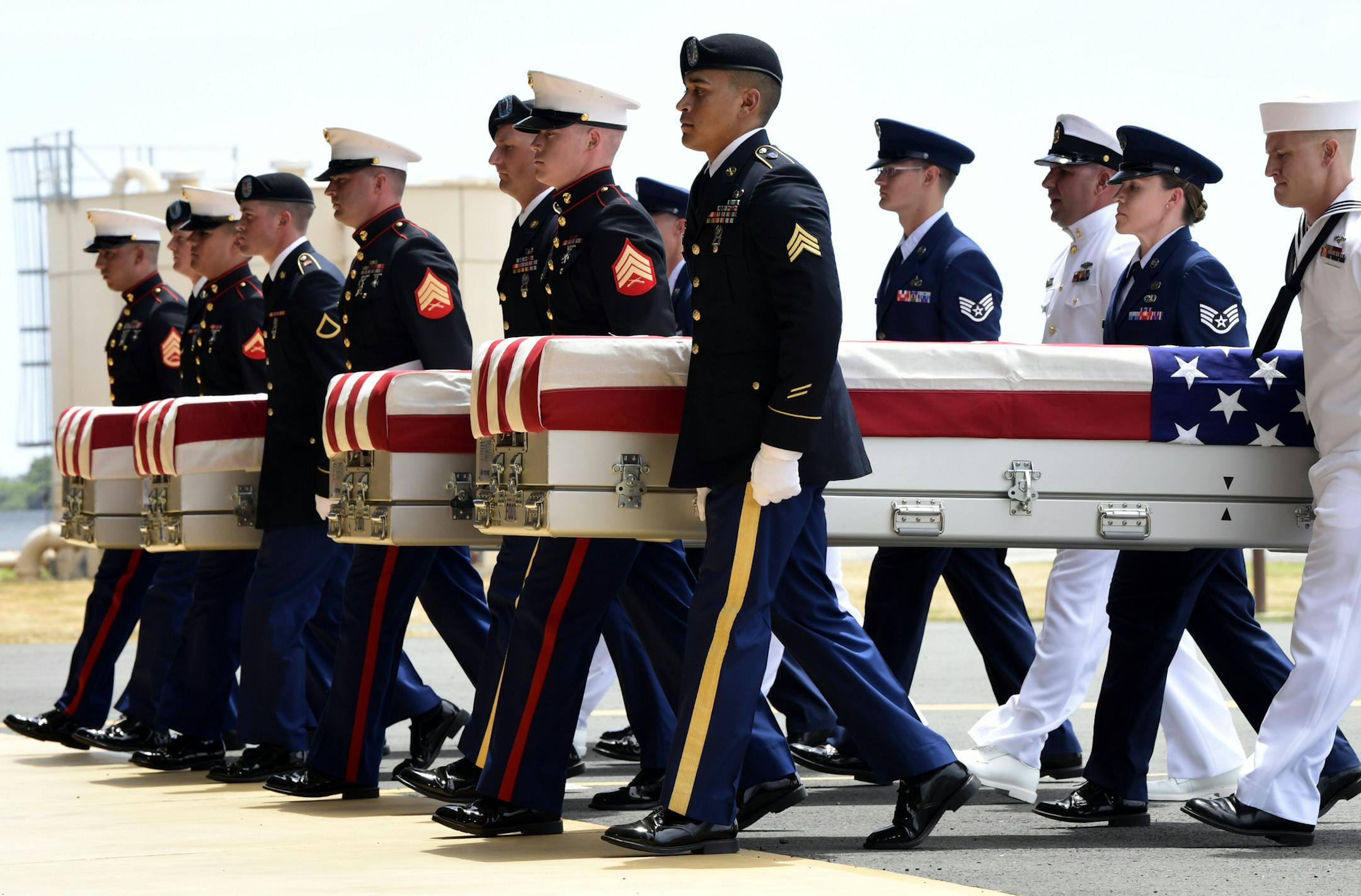 Members from all branches of the military carried transfer cases during a somber ceremony at Pearl Harbor, marking the arrival of the remains of what are believed to be U.S. servicemen from the Korean War. North Korea handed over the remains last week.