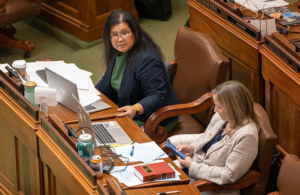 Rep. Kaohly Vang Her, sponsor of the Equal Rights Amendment bill, arrives at her desk on the House floor Monday before debate on her bill begins. 