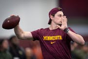 Gophers quarterback Max Brosmer helps run offensive drills during Gophers Pro Day at the University of Minnesota's Athletes Village on March 14.