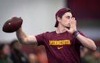 Gophers quarterback Max Brosmer helps run offensive drills during Gophers Pro Day at the University of Minnesota's Athletes Village on March 14.