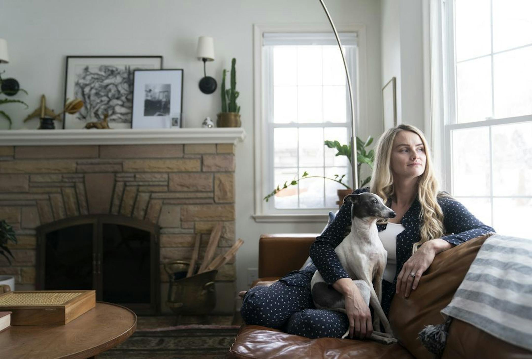Tasha Schultz, pictured in her living room, is a fan of vintage "brown" furniture.