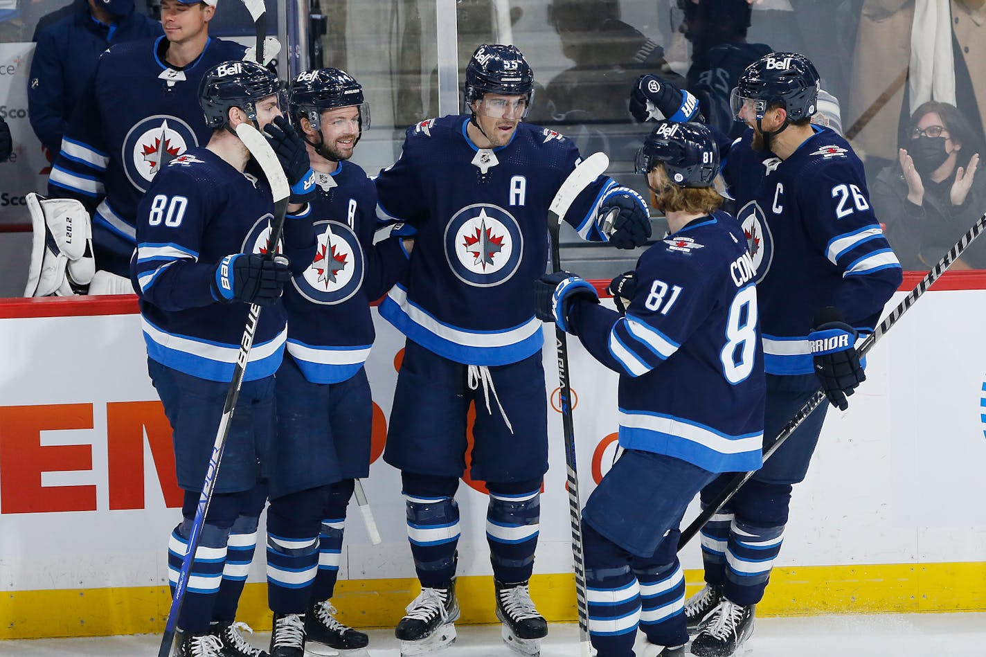 The Jets' Pierre-Luc Dubois (80), Josh Morrissey (44), Mark Scheifele (55), Kyle Connor (81) and Blake Wheeler (26) celebrated one of Scheifele's three goals in a 6-3 victory over the Wild on Wednesday.