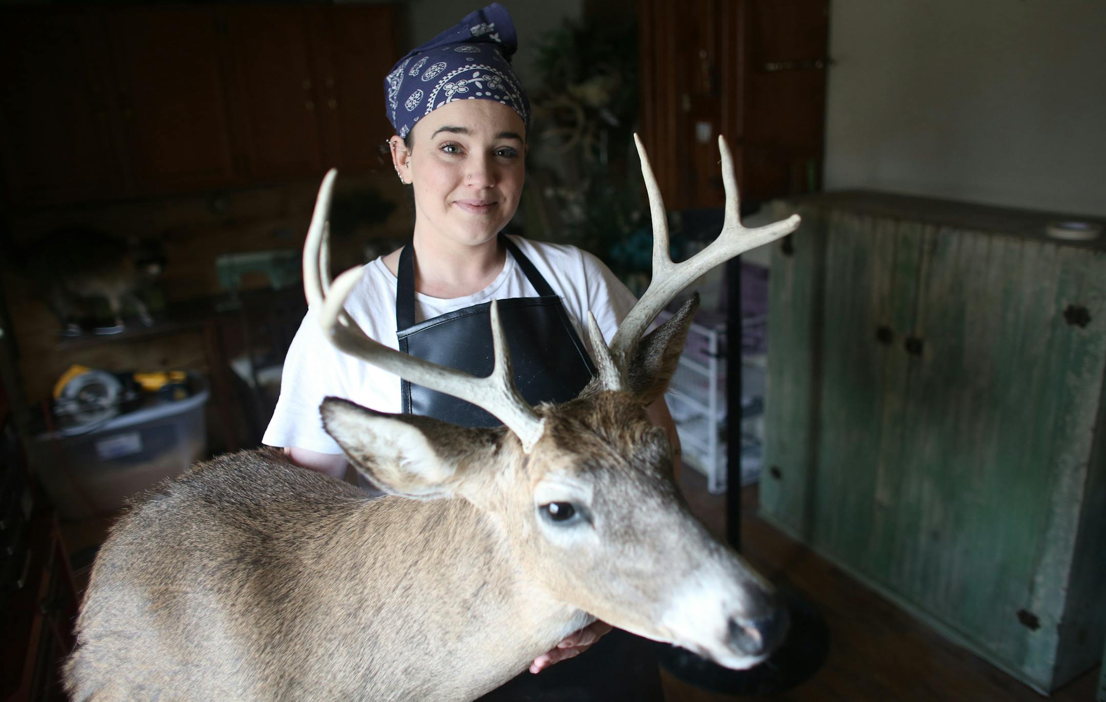 Taxidermist Tia Annis held up one of the deer heads she has mounted. Annis is an avid hunter and doesn't buy store-bought meat. She will hunt deer as well as fish and squirrel and she tries to let none of the animal go to waste. ] (KYNDELL HARKNESS/STAR TRIBUNE) kyndell.harkness@startribune.com Tia Annis, 33, might be the first taxidermist to set up shop in Chaska. As an avid hunter, she grew up with a "waste not, want not" attitude, regularly eating roadkill deer for dinner. This was shot Tuesd