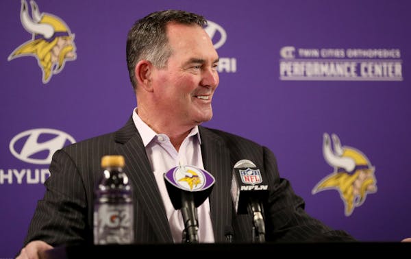 Minnesota Vikings head coach Mike Zimmer glances over at first round pick cornerback Mike Hughes from the University of Central Florida as he introduc