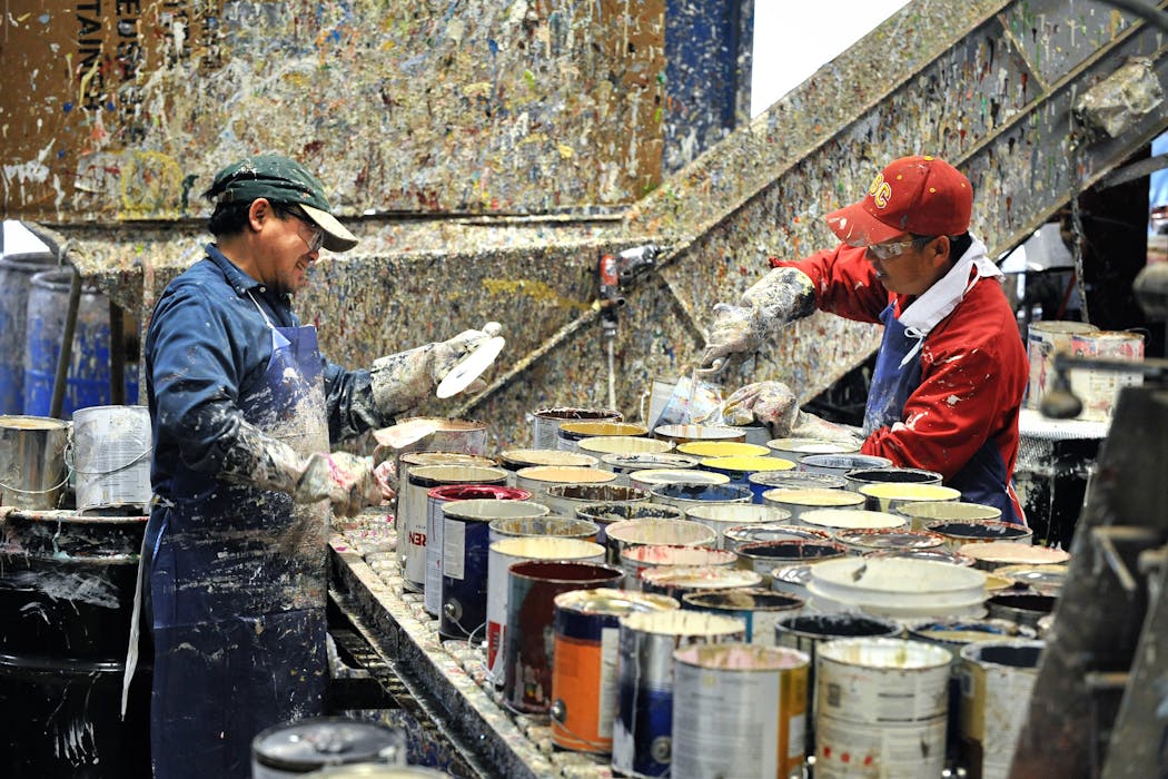 Workers at Amazon Environmental in Fridley opened cans of used paint to be recycled in 2009.