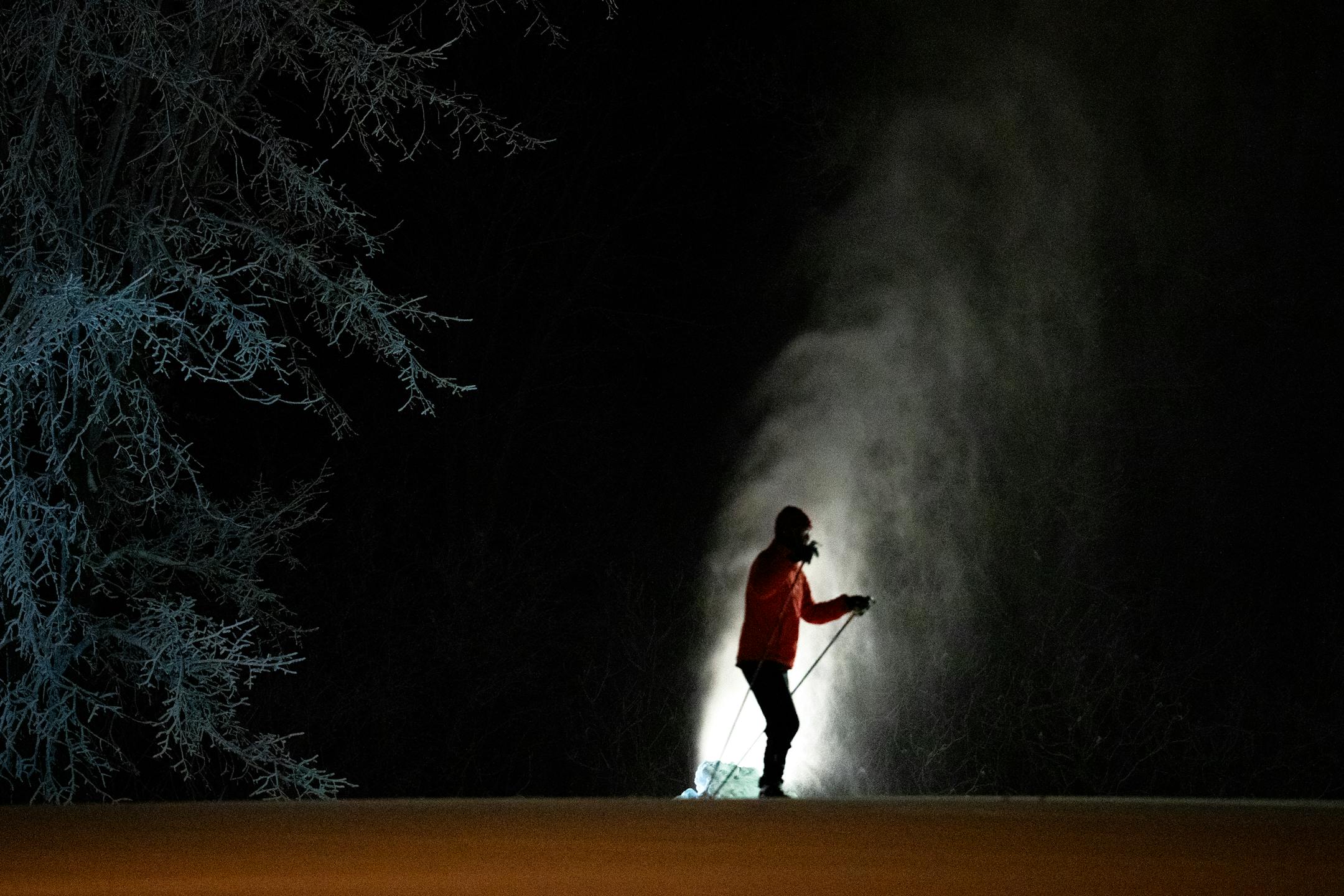 Snowmaking guns and skiers line the trails before the sun rises at the Elm Creek nordic ski area in Maple Grove , Minn., on Wednesday, Dec. 6, 2023. Elm Creek, part of Three Rivers Parks, makes snow from groundwater for cross country ski trails, tubing hill and snowboard park. ] SHARI L. GROSS • shari.gross@startribune.com