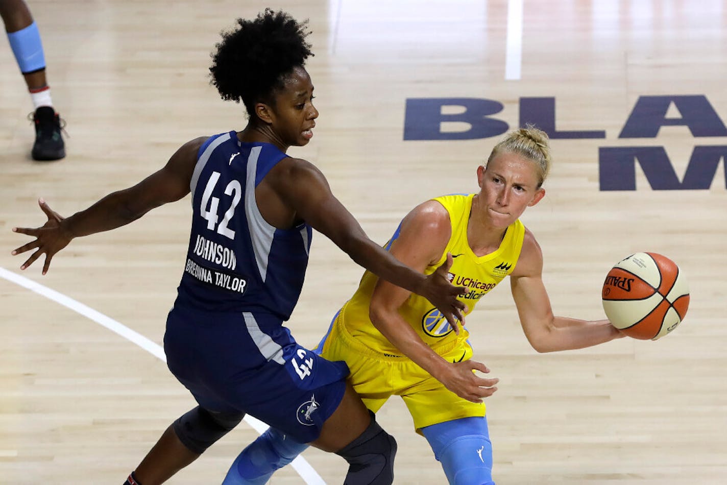 Chicago Sky guard Courtney Vandersloot (22) looks to pass around Minnesota Lynx guard Shenise Johnson (42) during the second half,