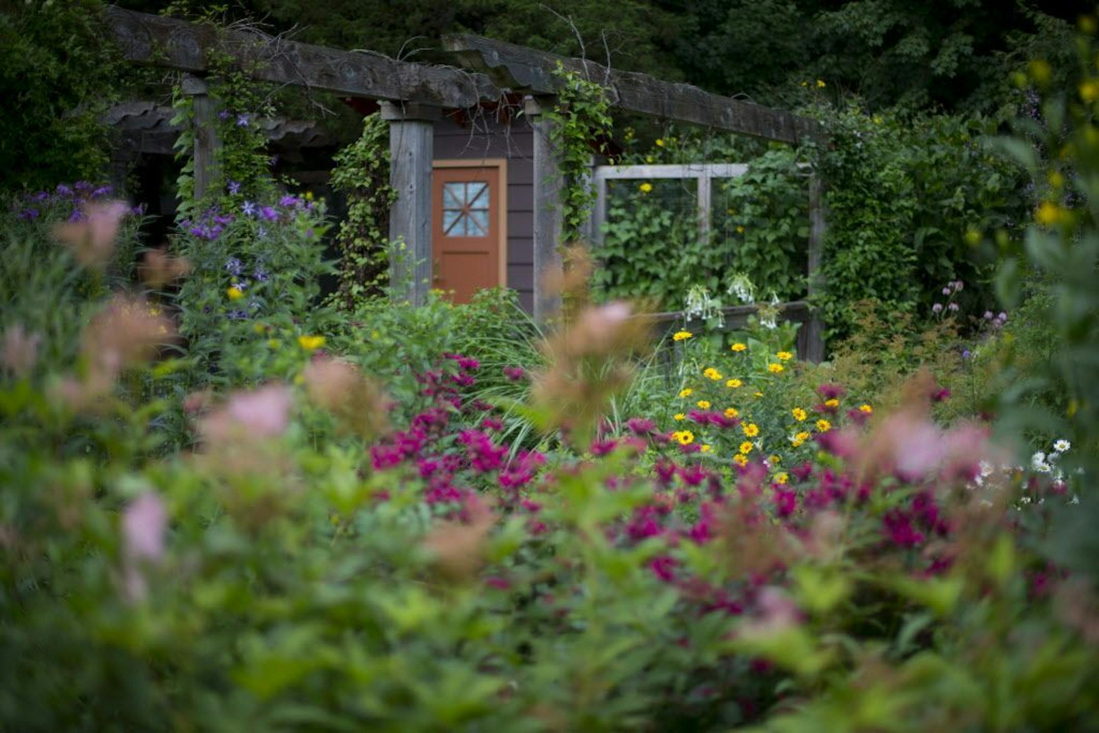 The front of the house has a large garden encased in a stone wall, complete with a vegetable garden.