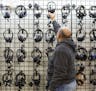 A shopper looks at a wall of headphones at the Unclaimed Baggage Center in Scottsboro, Ala., Nov. 19, 2014. While the number of checked &#xec;mishandl