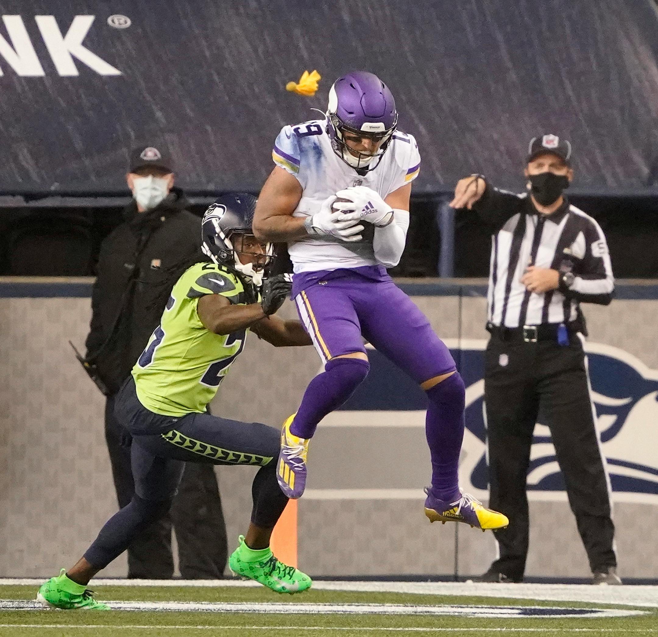 Minnesota Vikings' Adam Thielen, right, catches a touchdown pass as Seattle Seahawks' Shaquill Griffin defends during the second half of an NFL football game, Sunday, Oct. 11, 2020, in Seattle. (AP Photo/Ted S. Warren)