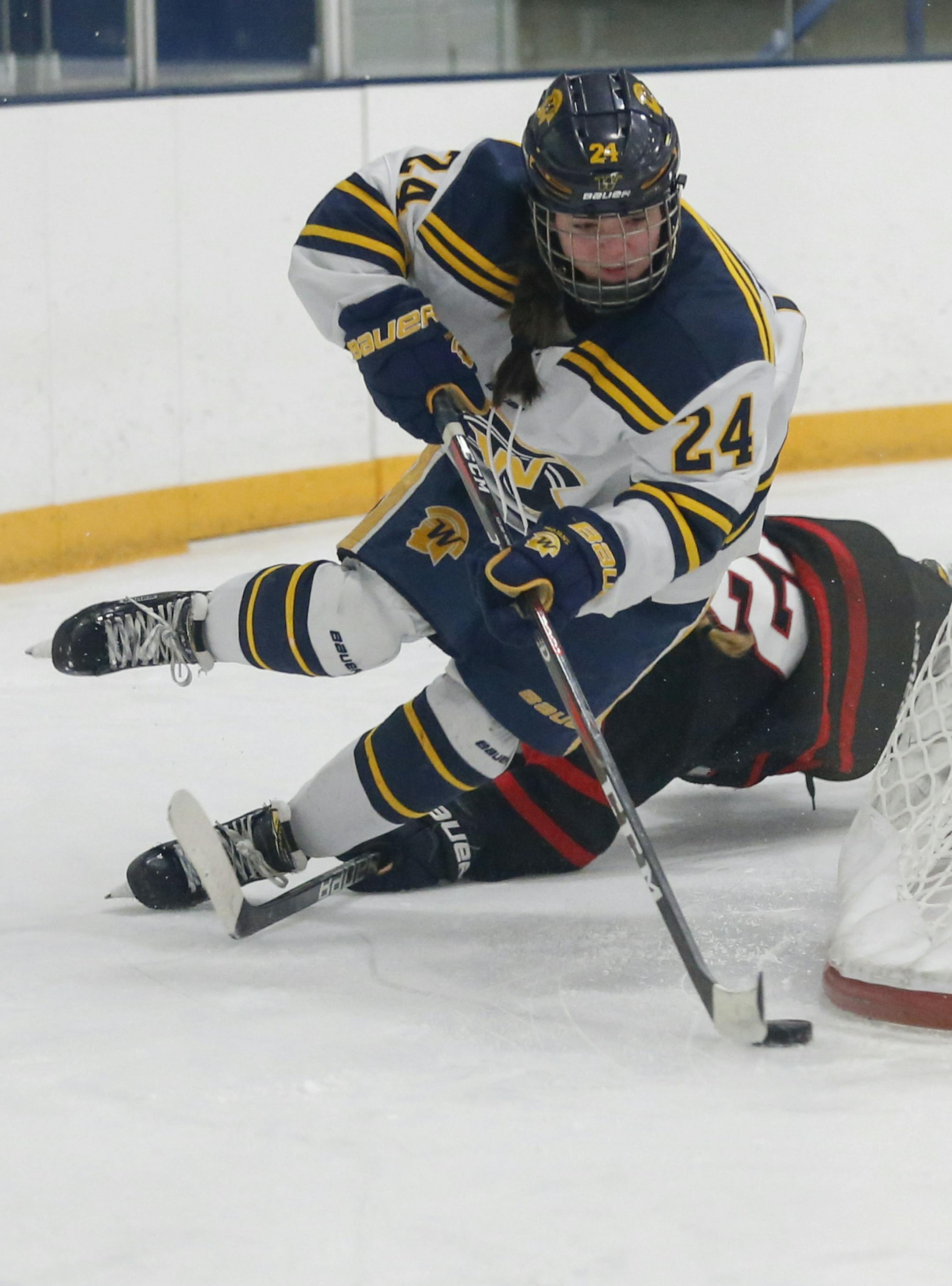 Wayzata's Gretchen Branton (24) lost her balance as she drove around the net to try and score against Eden Prairie. Eden Prairie Eagles vs Wayzata Trojans Plymouth Community Center January 3, 2019. Photo by Jeff Lawler, SportsEngine