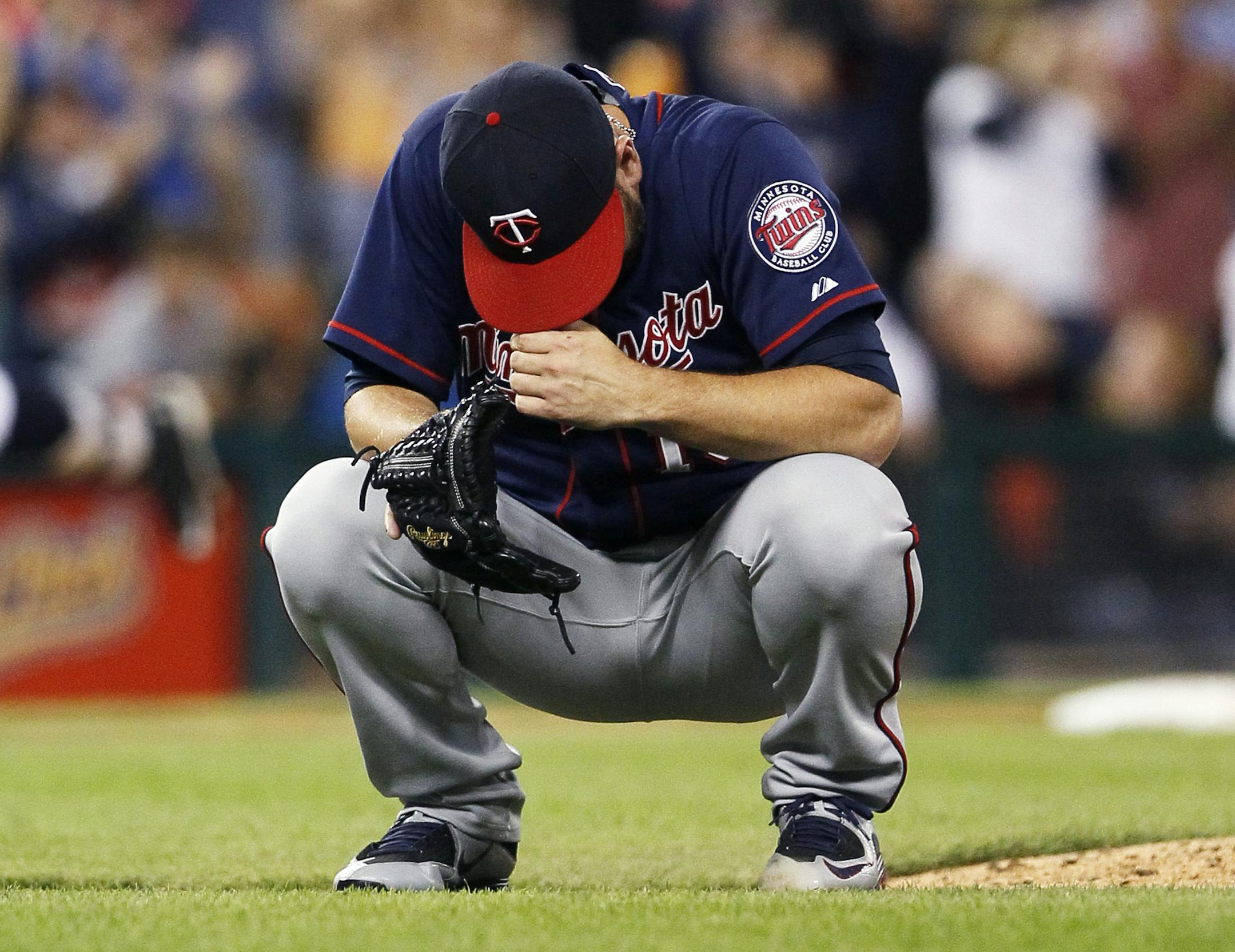 Minnesota Twins pitcher Glen Perkins reacts after giving up a two-run home run to Detroit Tigers' Rajai Davis during the eighth inning of a baseball game at Comerica Park, Friday, Sept. 25, 2015, in Detroit. (AP Photo/Duane Burleson)