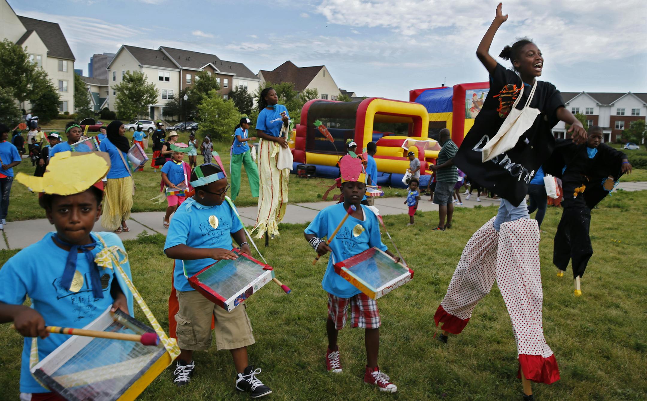 At National Night Out in Heritage Park, Jasmine Salter, 12, far right, walked on stilts as part of a parade of kids from the Phyllis Wheatley Center summer program.