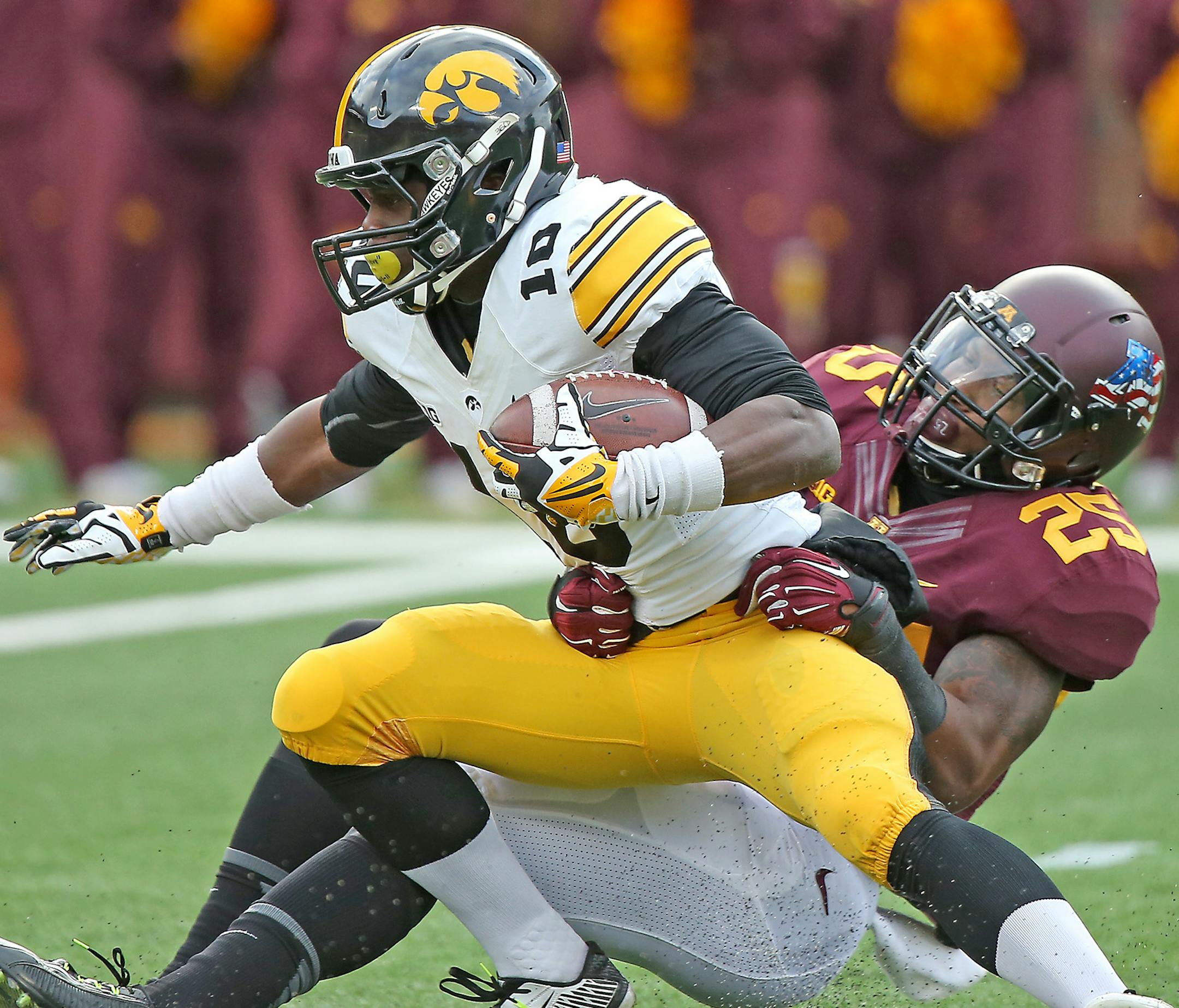 Minnesota's wide receiver Devon Wright took down Iowa's running back Jonathan Parker (10) in the first quarter as the Gophers took on the Iowa Hawkeyes, Saturday, November 8, 2014 at TCF Stadium in Minneapolis, MN. ] (ELIZABETH FLORES/STAR TRIBUNE) ELIZABETH FLORES • eflores@startribune.com