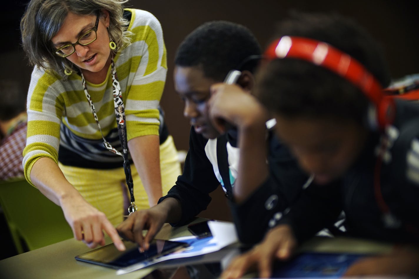 At the Maplewood library, teen librarian Amy Boese helped Amier Day,12, with Garage Band as he was trying to create a catchy tune. Using the tablet is a fun way to gain computer literacy ] Richard Tsong-Taatarii/rtsong-taatarii@startribune.com