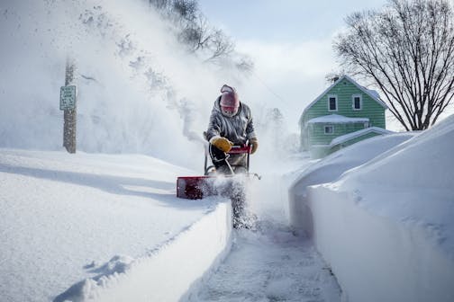 Michael Mueller snow blows the sidewalk near his house Sunday, Feb. 24, 2019, in Rochester after heavy snow overnight. Joe Ahlquist / jahlquist@postbulletin.com