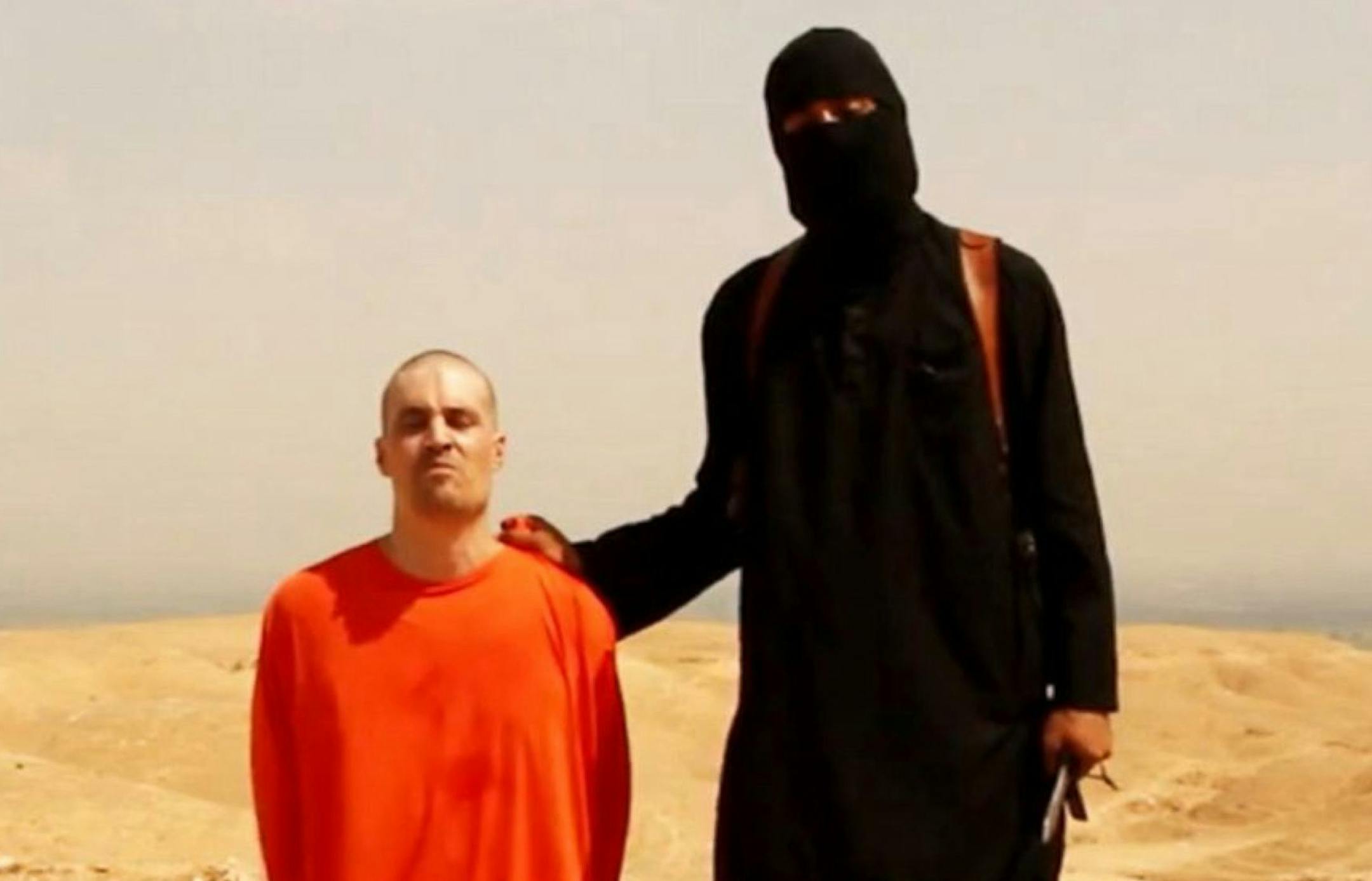 A videograd shows a masked Islamic State (ISIS) militant holding a knife speaks next to man purported to be U.S. journalist James Foley at an unknown location in this still image from an undated video posted on a social media website. Islamic State insurgents released the video on August 19, 2014 purportedly showing the beheading of Foley, who had gone missing in Syria nearly two years ago, and images of another U.S. journalist whose life they said depended on U.S. action in Iraq. The video, tit
