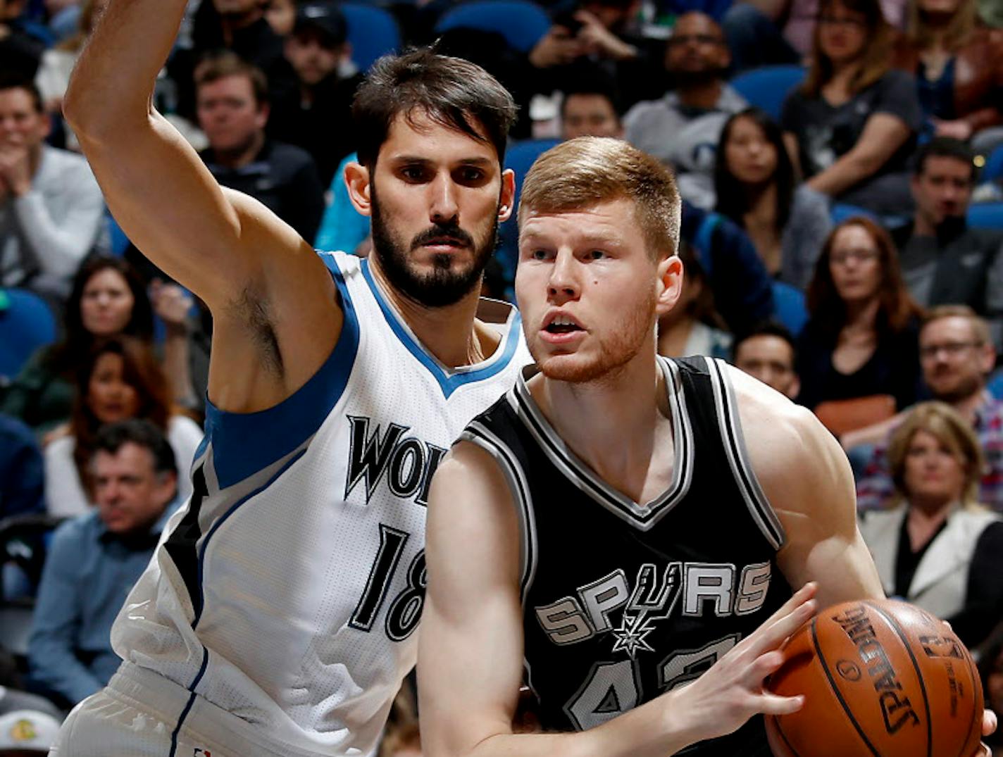 The Wolves' Omri Casspi, left, defending San Antonio's Davis Bertans, is learning new teammates and a new system while also recovering from a broken thumb.