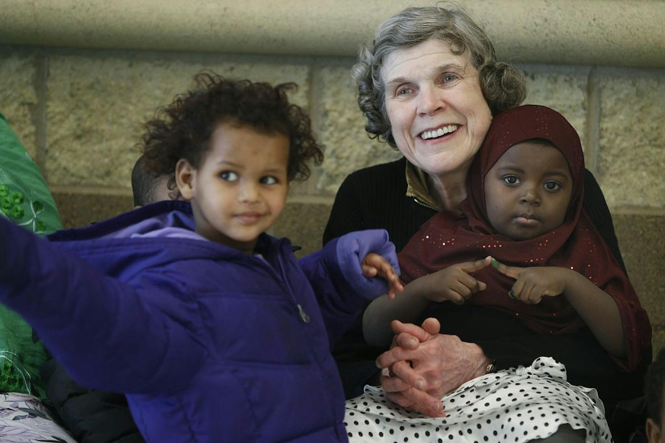 Mary Jo Copeland greeted residents with hugs and kisses including Ayan Ahmed, 3, left, and Nasib Ali, 3, at Sharing and Caring Hands Friday, February 8, 2013 near downtown Minneapolis. Copeland will receive a prestigious civilian award from President Barack Obama next week . (ELIZABETH FLORES/STAR TRIBUNE) ELIZABETH FLORES � eflores@startribune.com