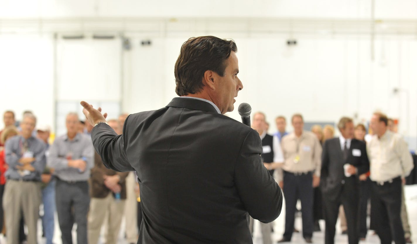 Tom Petters spoke to employees and invited guests at an open house for Petters Aviation at Minneapolis St. Paul International Airport.