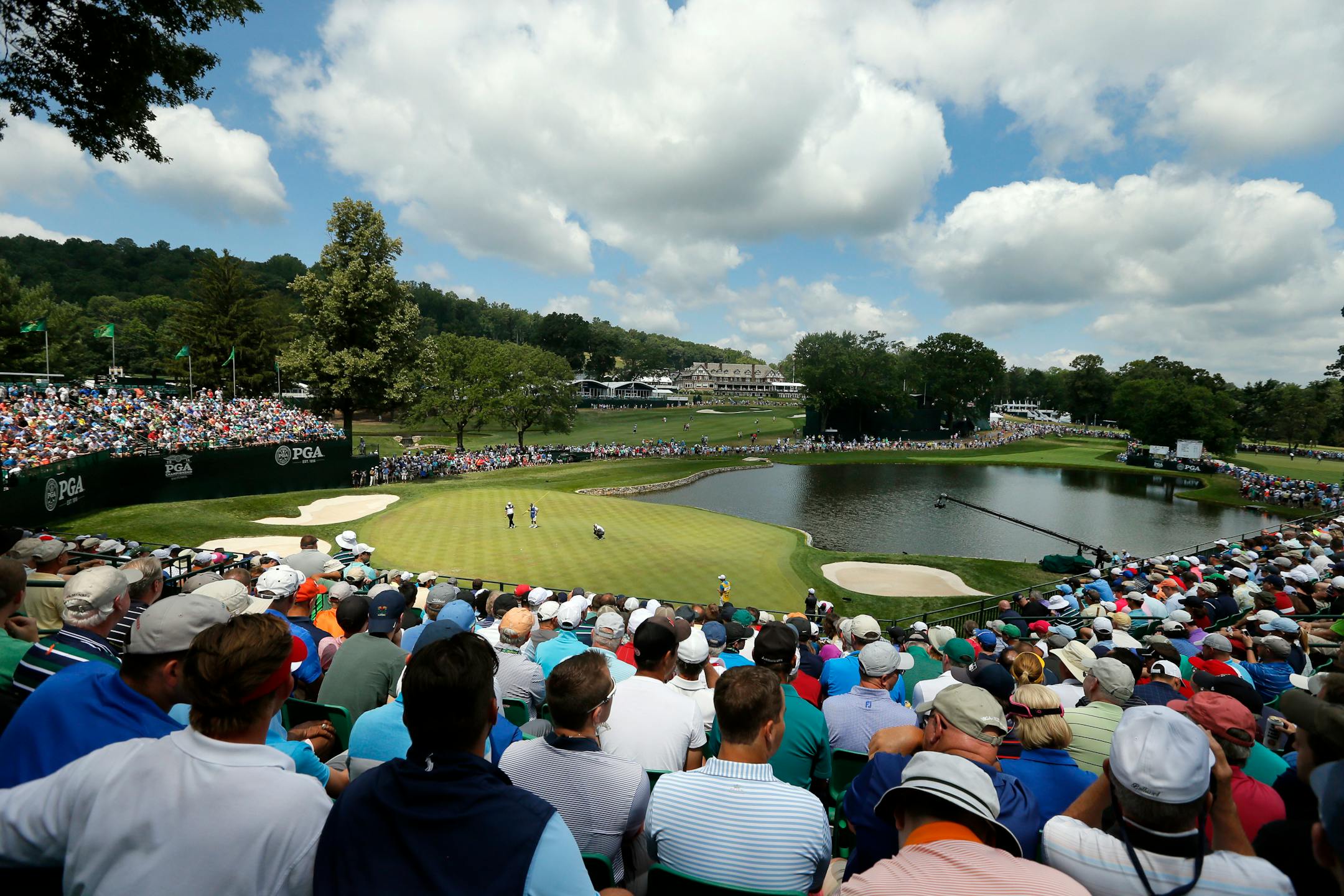 Fans watch as golfers play not he fourth green during the second round of the PGA Championship golf tournament at Baltusrol Golf Club in Springfield, N.J., Friday, July 29, 2016. (AP Photo/Tony Gutierrez)