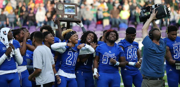 The Minneapolis North Polars celebrated with their championship trophy after defeating Rushford-Peterson 30-14 in the Class 1A title game. ] Shari L. 