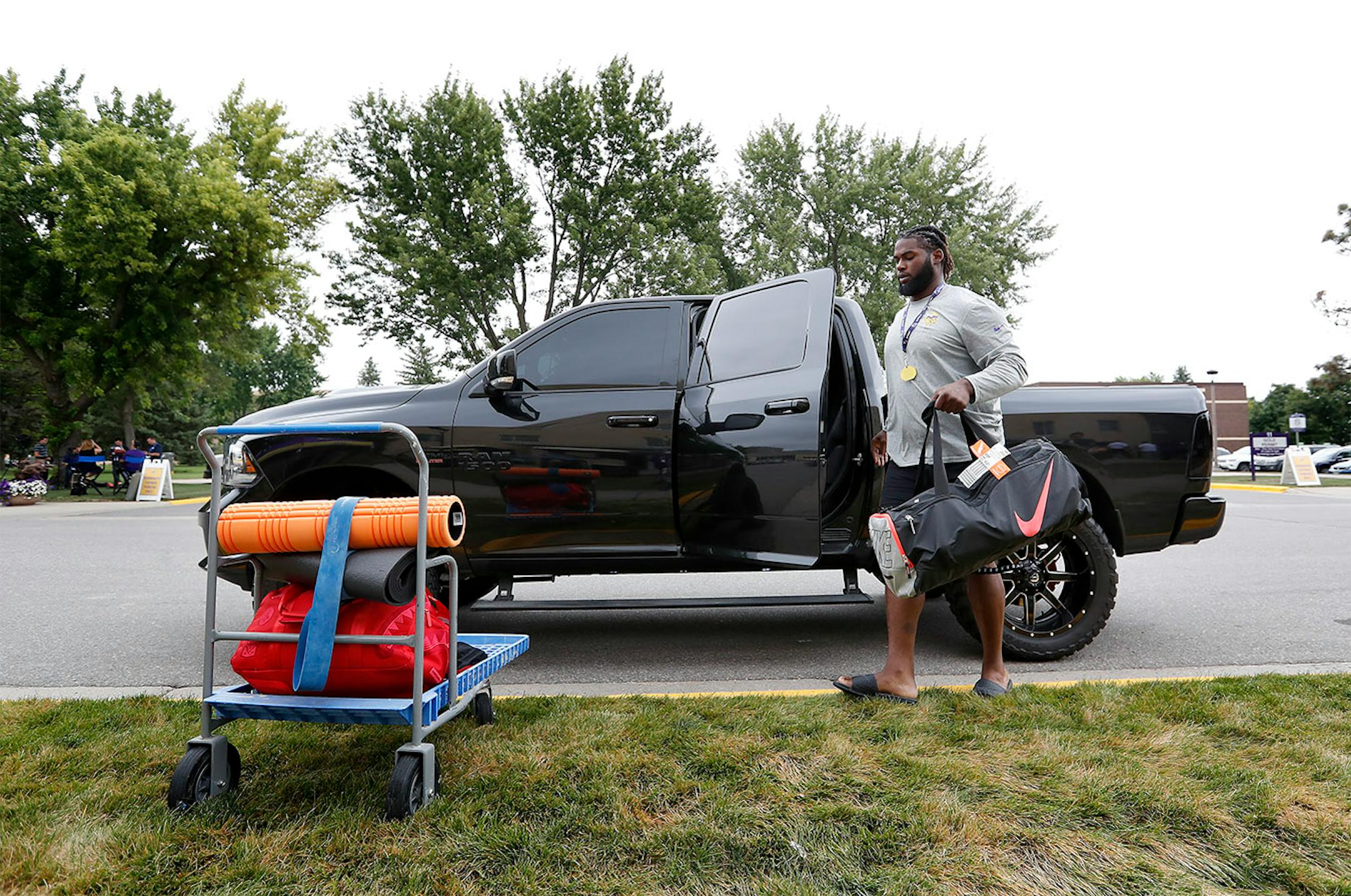 Sharrif Floyd unloaded his vehicle during after checking in for training camp.