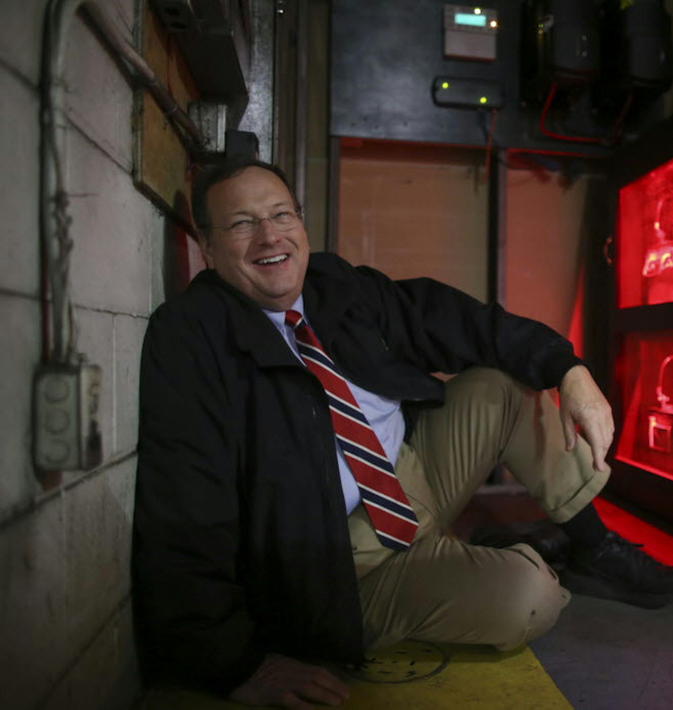 Richard Murphy with batteries charged by a rooftop solar array that power the backup power supply for the computer system at the Murphy Warehouse campus in Minneapolis.