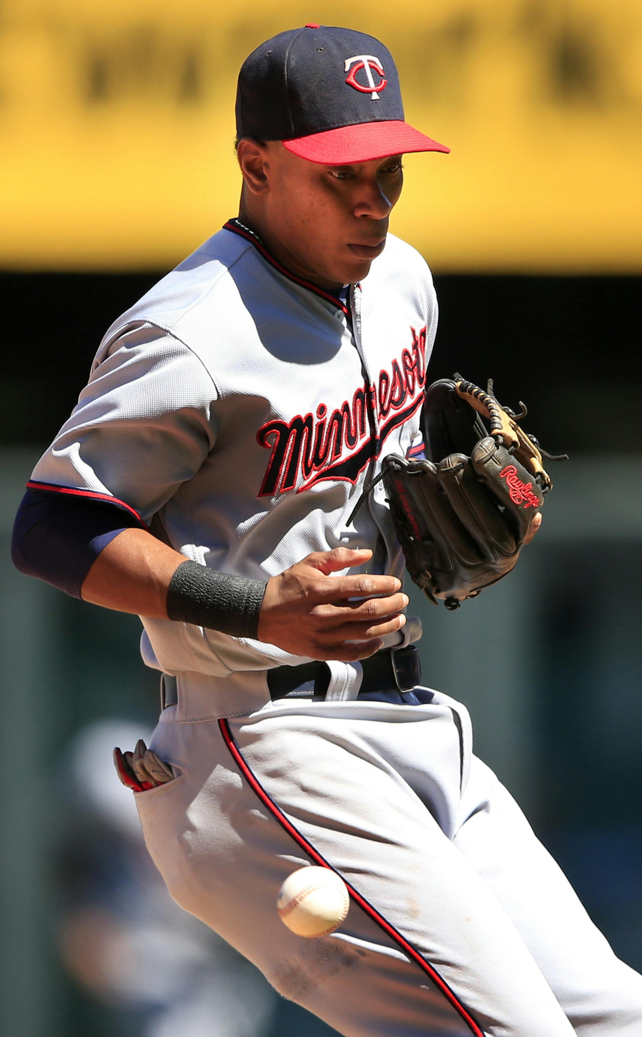 Minnesota Twins shortstop Jorge Polanco fails to handle a ball hit by Kansas City Royals' Lorenzo Cain during the sixth inning of a baseball game at Kauffman Stadium in Kansas City, Mo., Sunday, Aug. 21, 2016. Cain singled on the play. (AP Photo/Orlin Wagner)