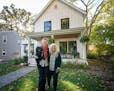 Colleen Carey and Pam Endean with their dog Cricket in front of their South Minneapolis urban farmhouse.